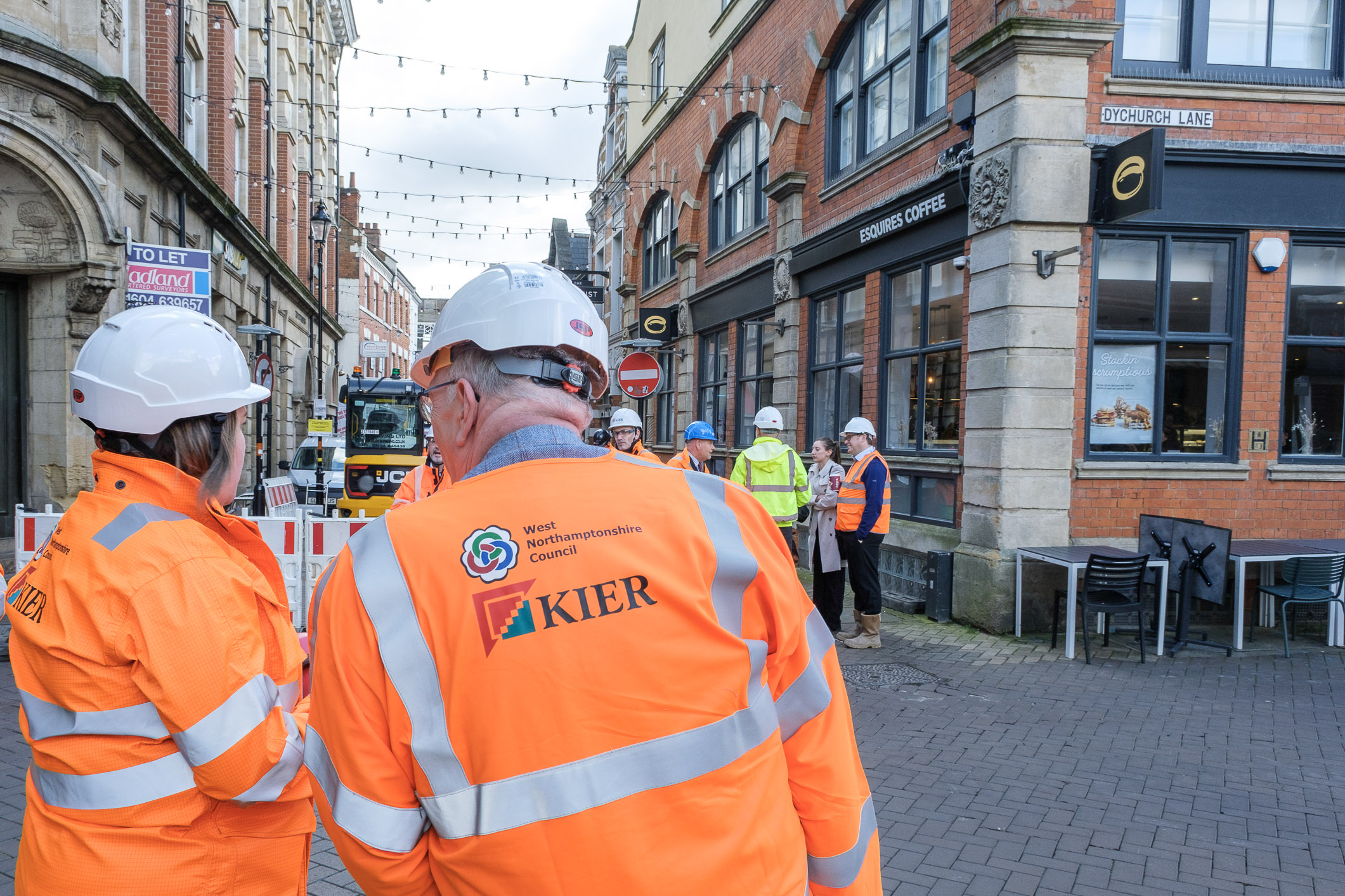 Two workers in WNC Keir branded high-viz jackets look at construction work taking place on Fish Street