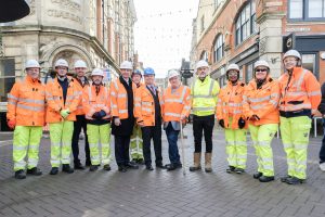 Workers in high-viz jackets posing in front of construction work on Fish Street.